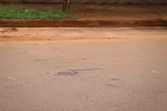 Sangue da vítima ficou na rua onde ela foi assassinada (Foto: Henrique Kawaminami/Campo Grande News)