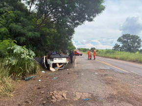 Fiat Uno com as quatro rodas para cima às margens da pista (Foto: Clara Farias/Campo Grande News)